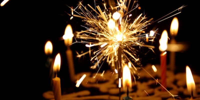 a sparkler on a birthday cake